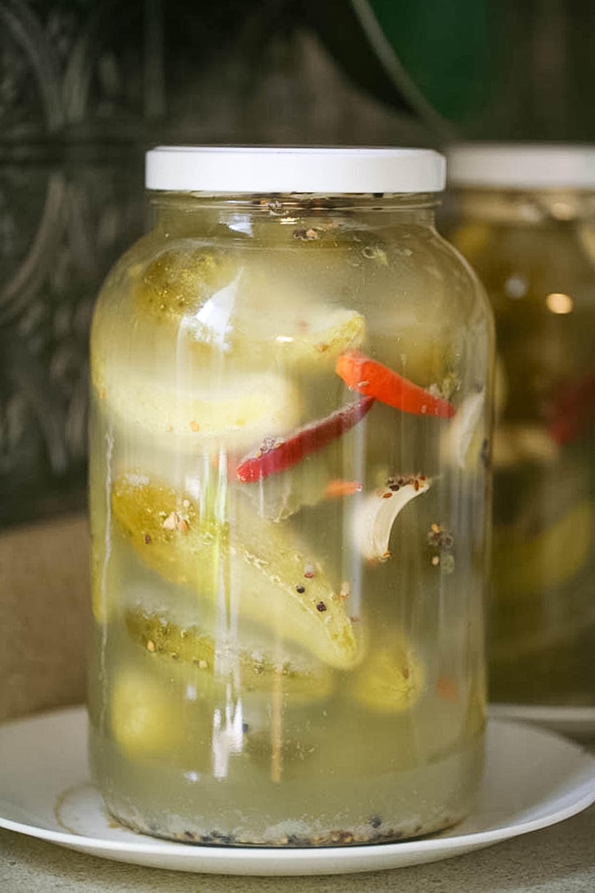 A jar of fermenting cucumbers during fermentation.