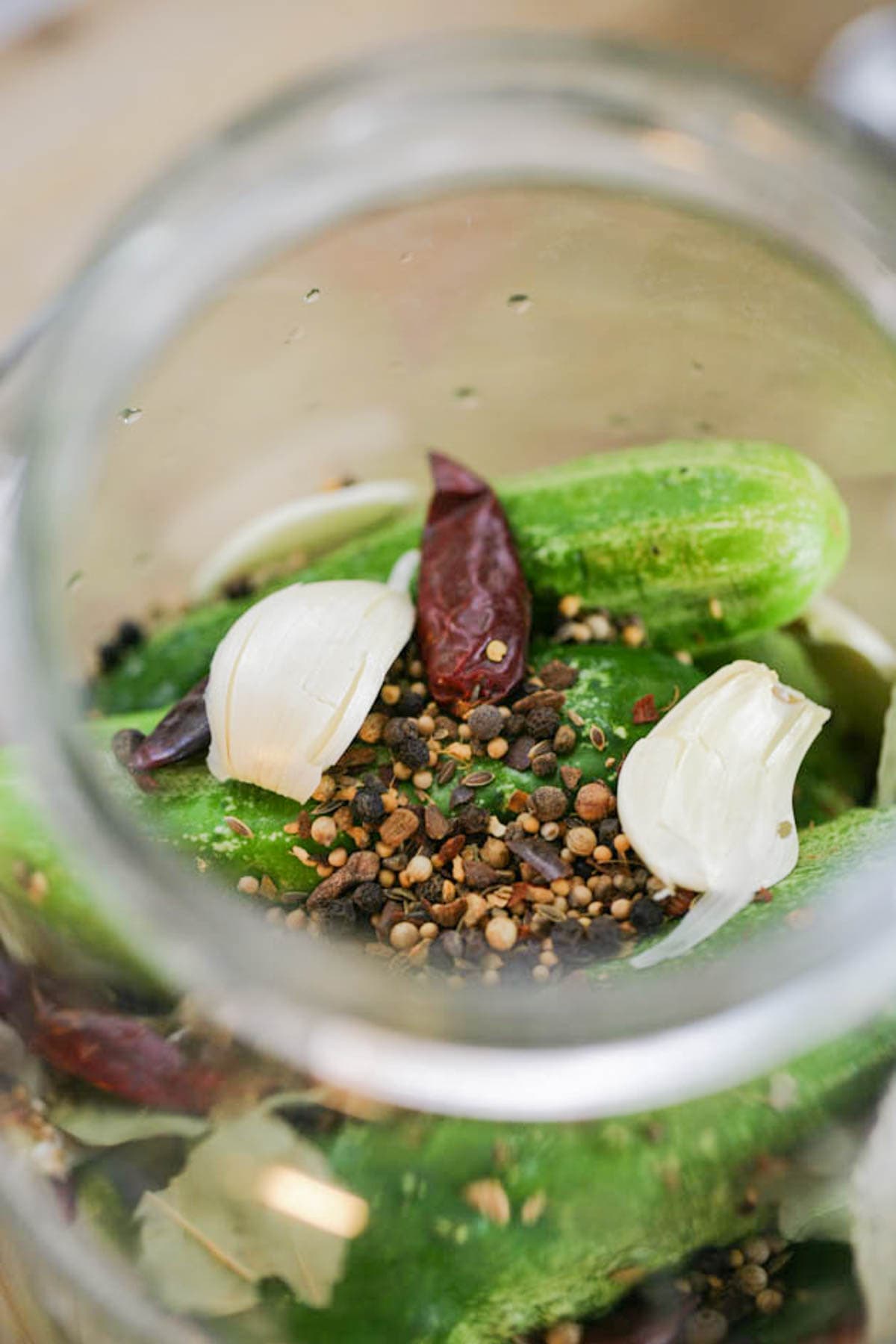 Adding spices to the jar.