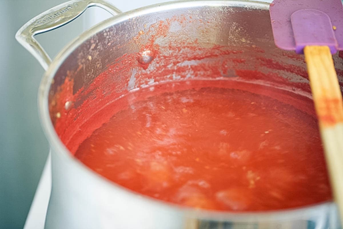 Cooking the tomato suce until reduced.