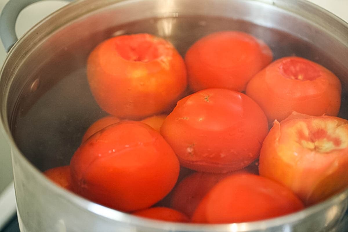 Tomatoes blanching in boiling water.