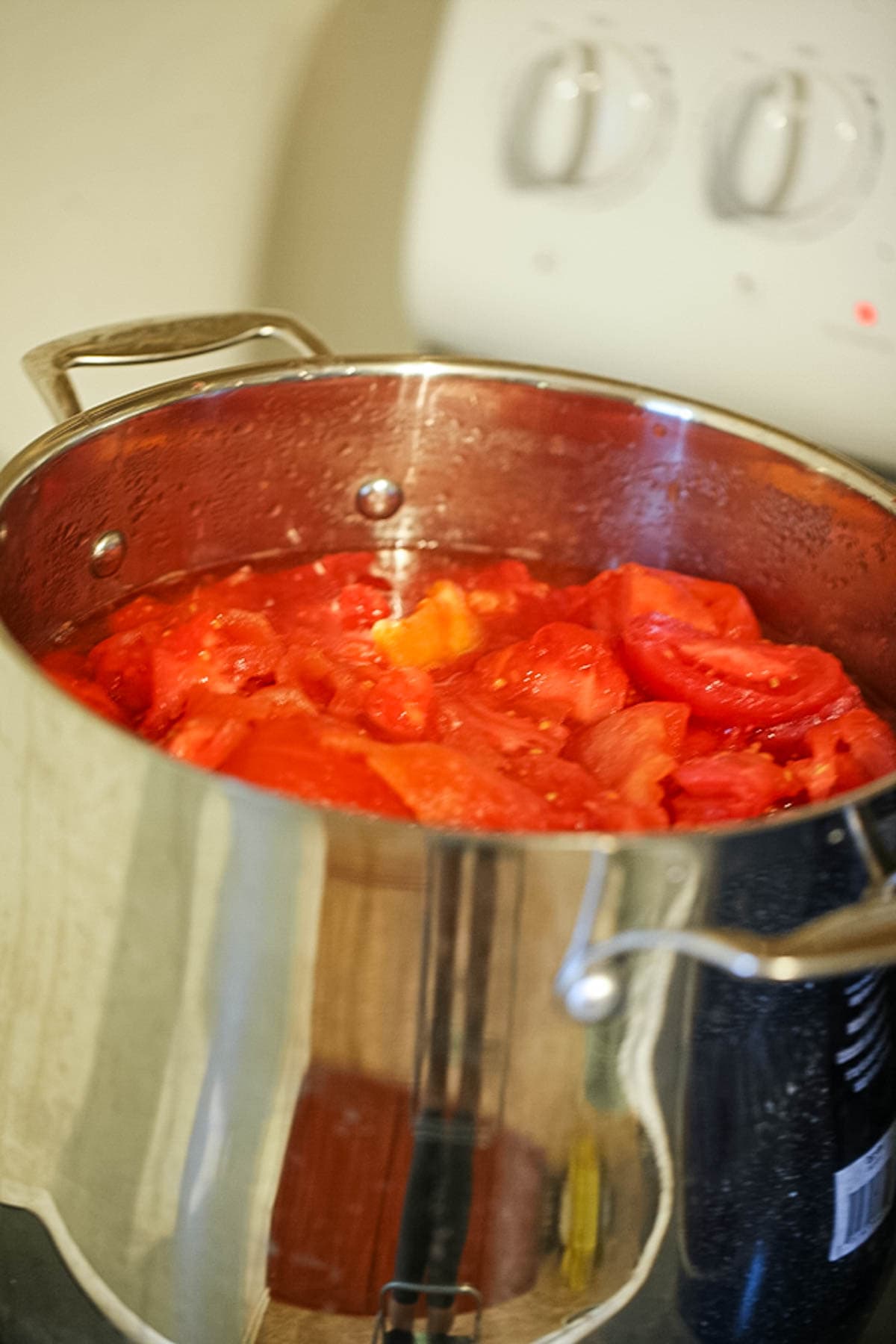 Cooking the tomatoes into sauce.