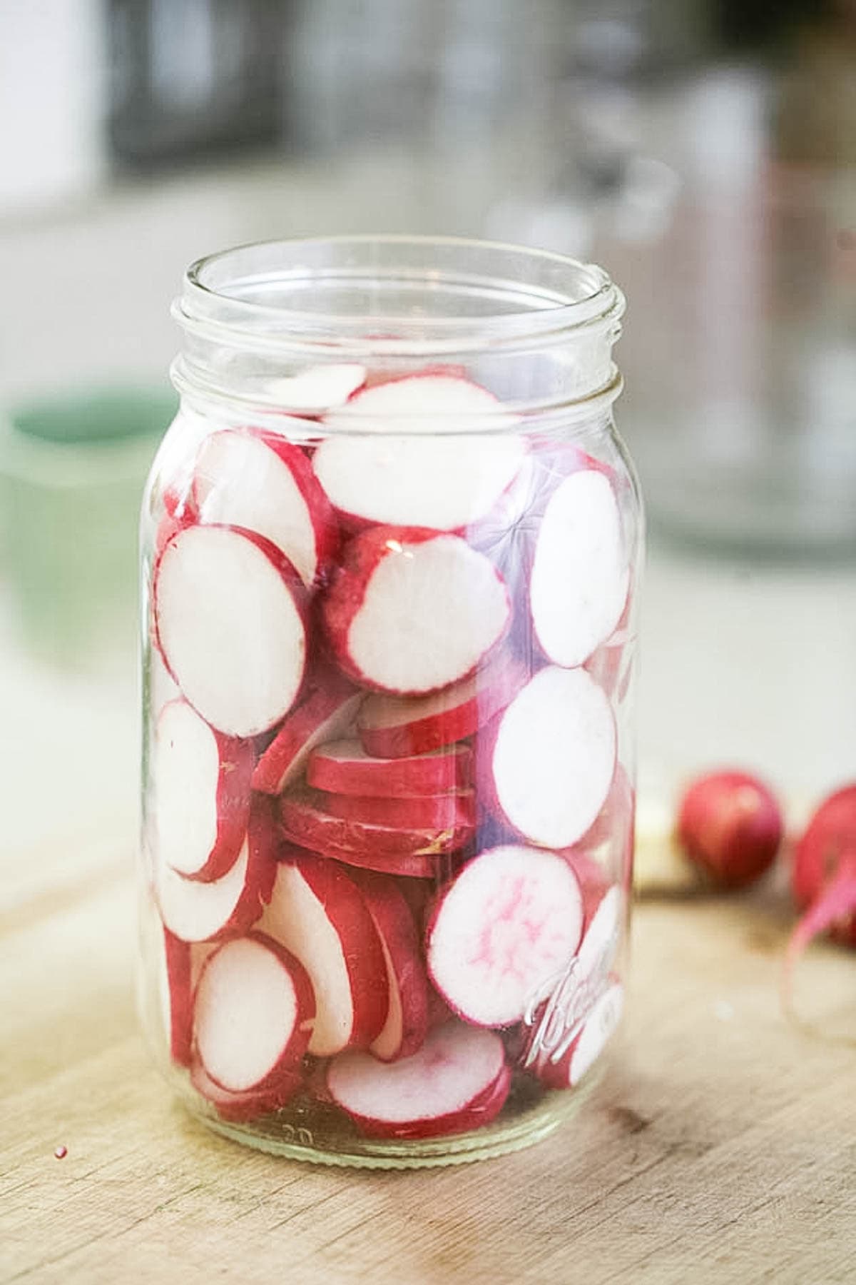 Packing the jar with radishes.