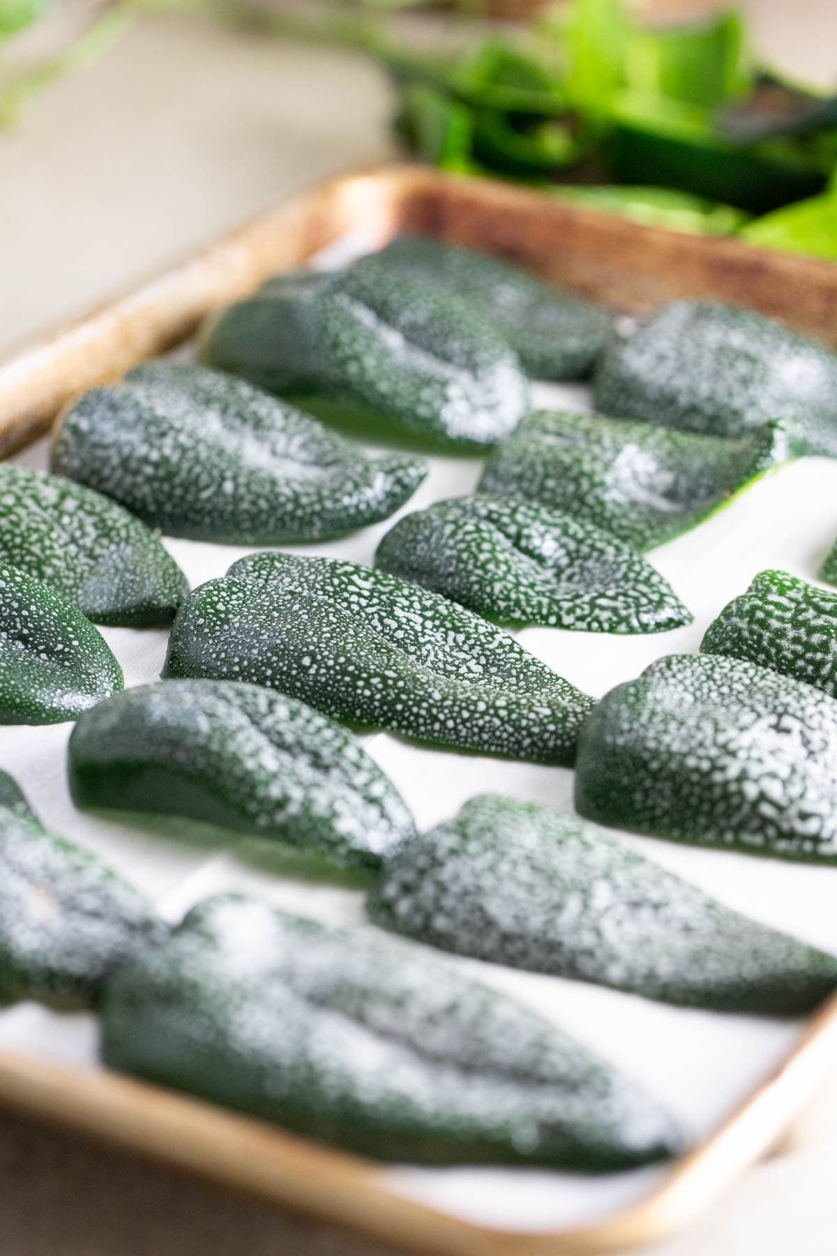 poblano peppers on a baking sheet sprayed with oil