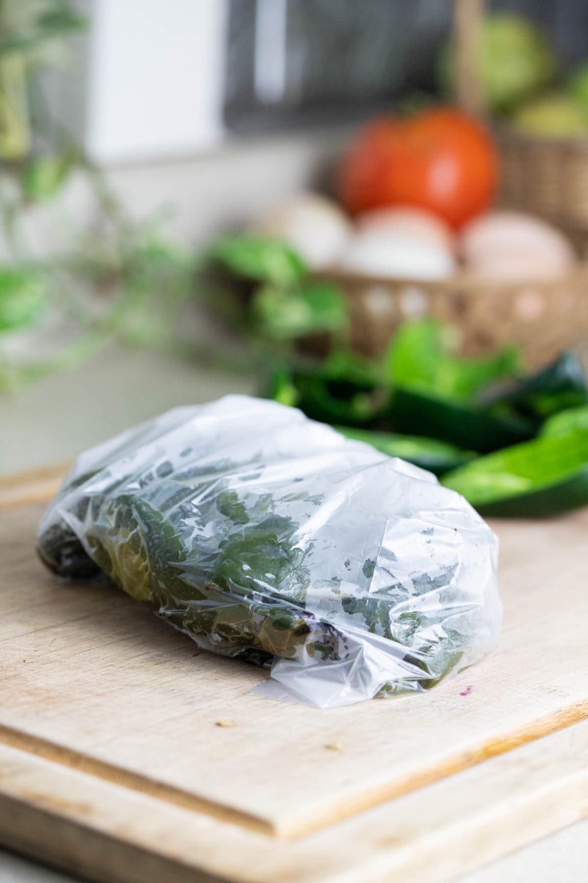 Roasted poblano peppers in a plastic bag.