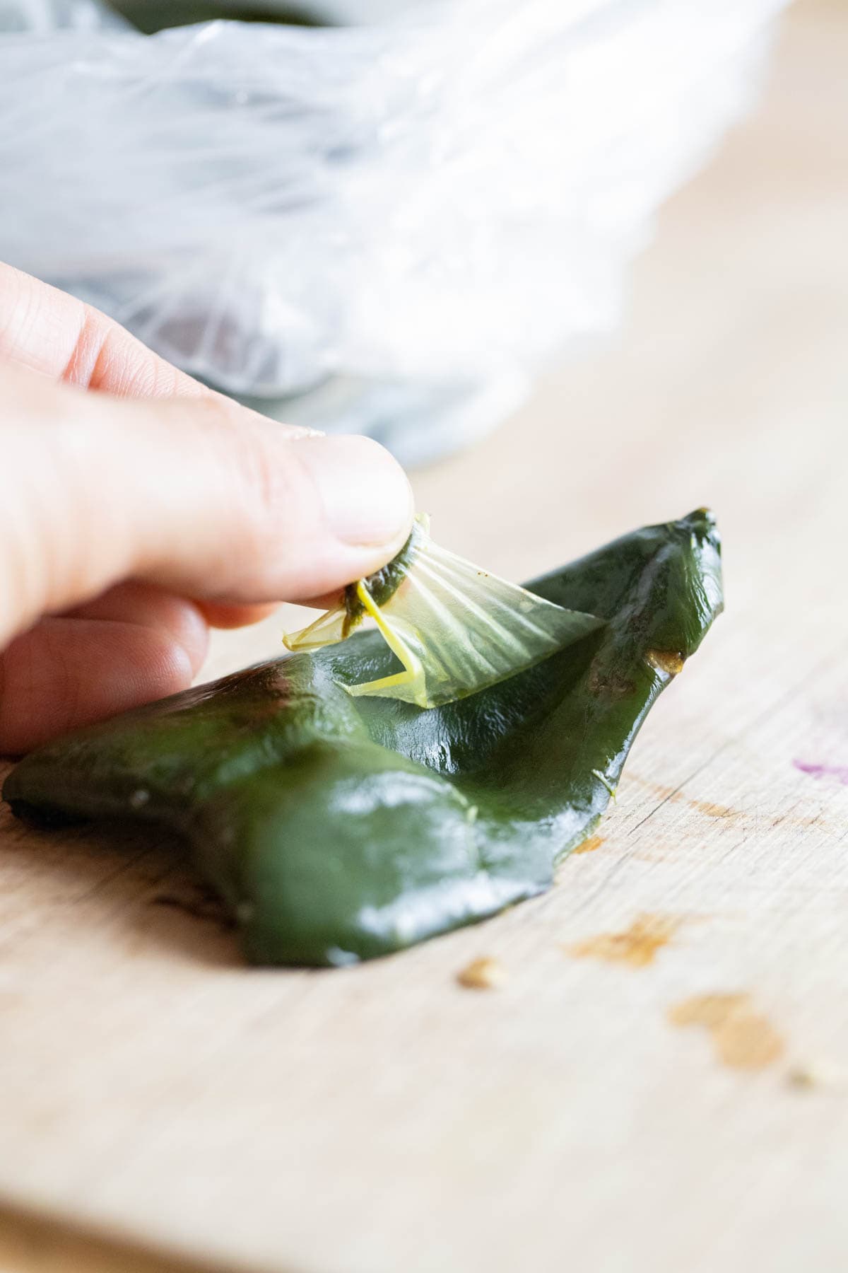 peeling the skin of roasted poblano peppers.
