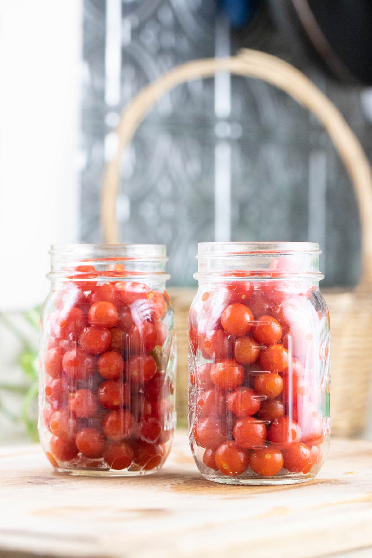 Packing cherry tomatoes in jars for canning.
