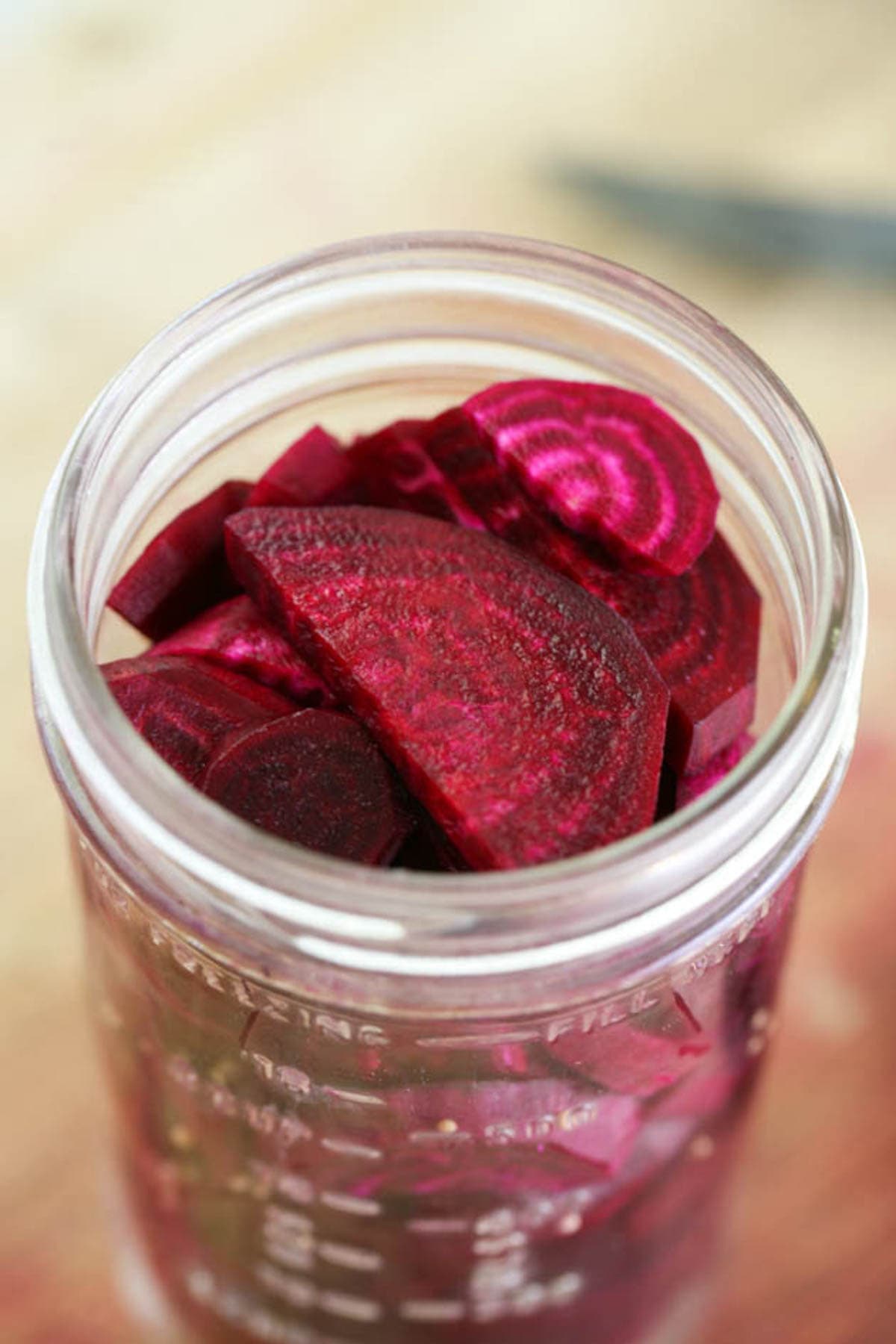 Packing the jar with beets slices and seasonings