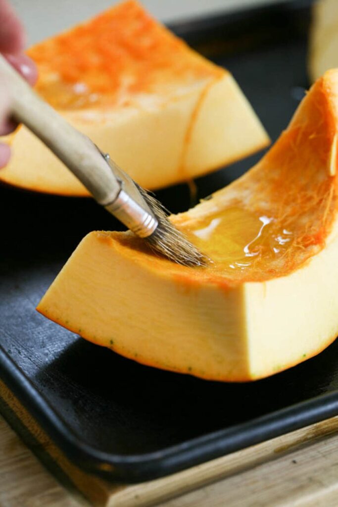 brushing pumpkin with olive oil