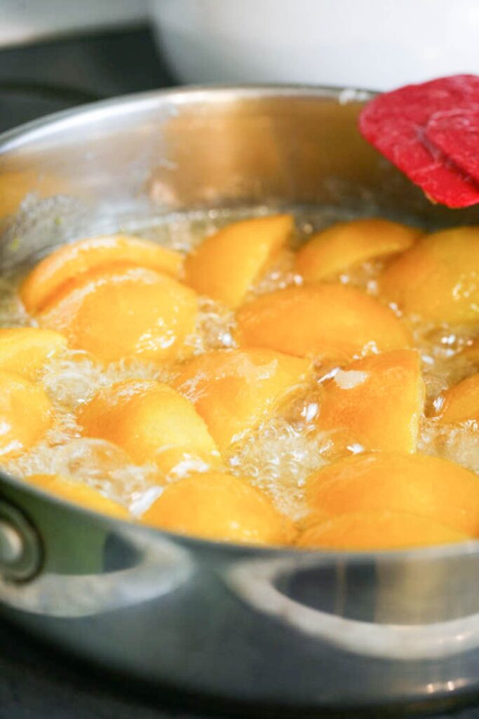 bringing the sugar and oranges mixture to a boil