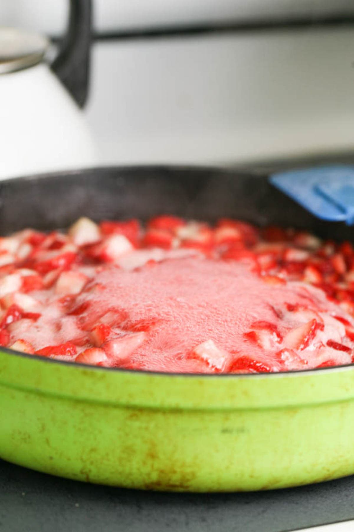 bringing strawberries and sugar to a boil