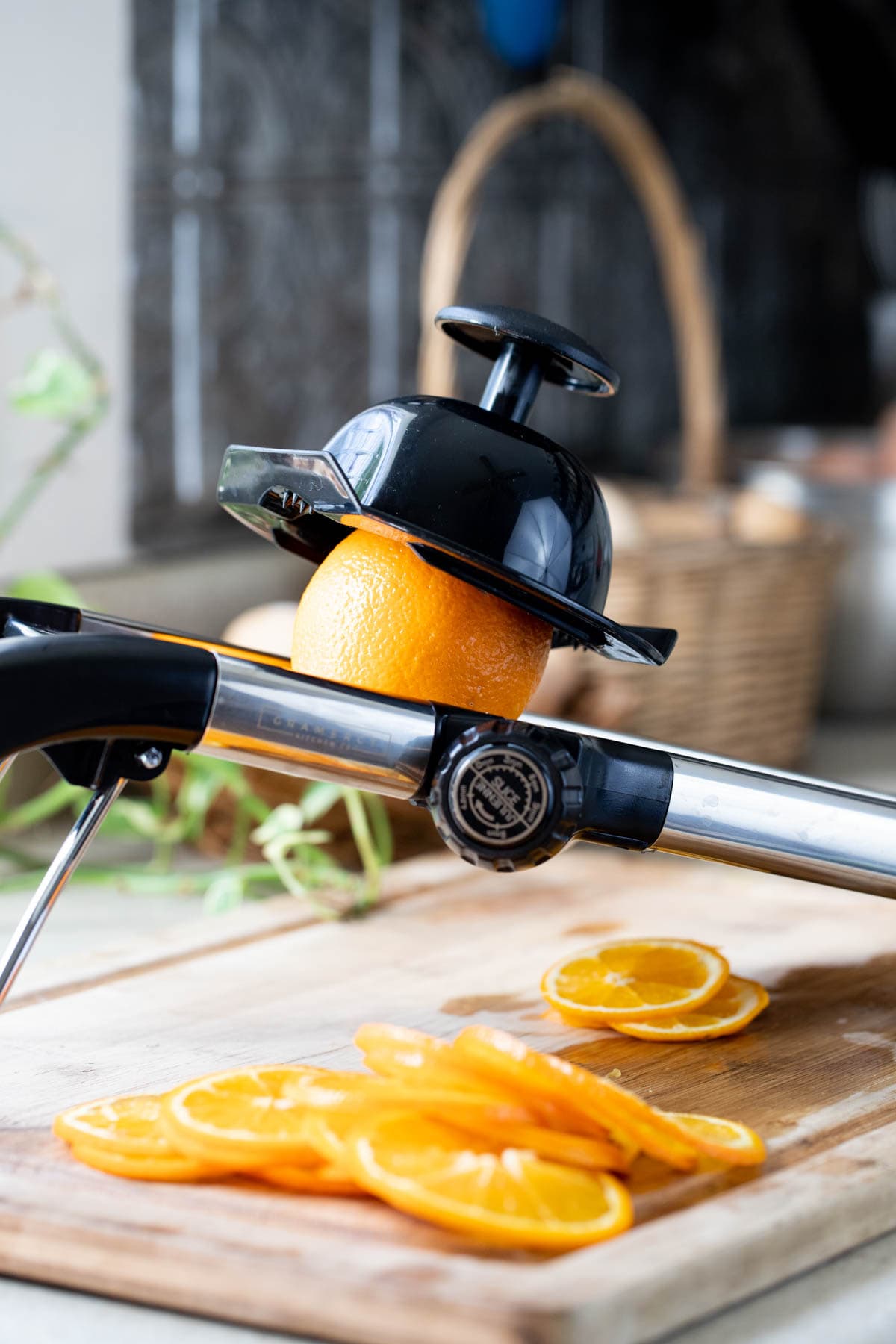 using a kitchen mandolin to slice the oranges