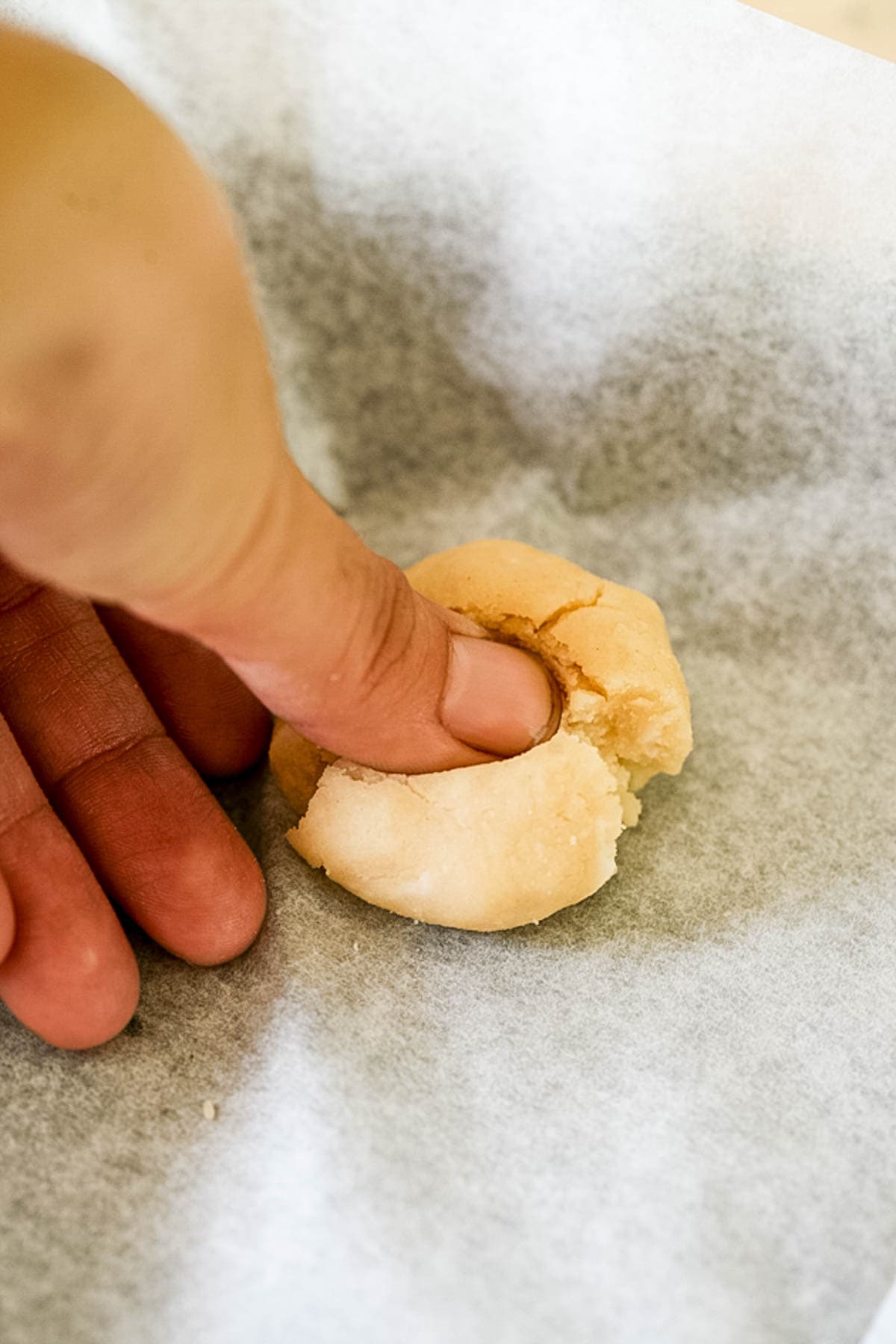 using thumb to shape the dough
