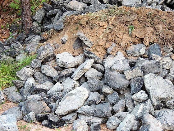large rock leftover from the asphalt driveway