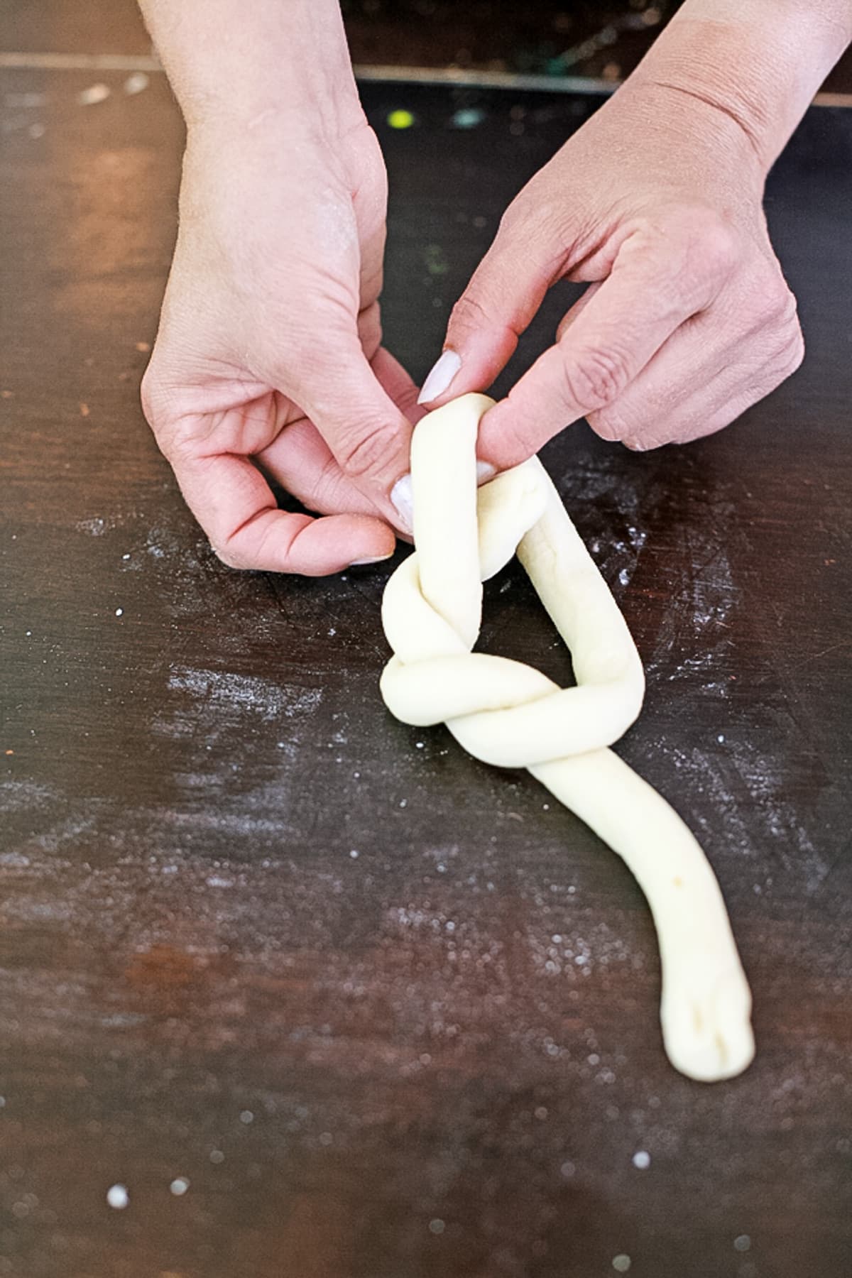 looping one end over the ring of dough
