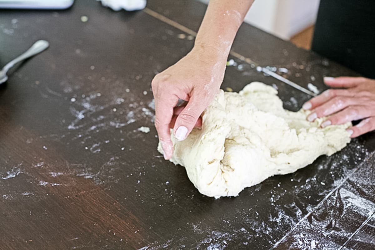 hand kneading the challah dough