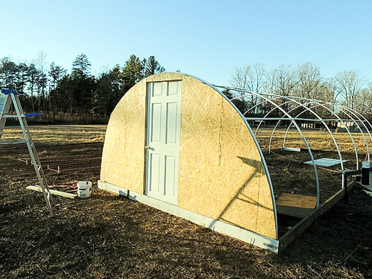 installing the plywood at the ends of the greenhouse