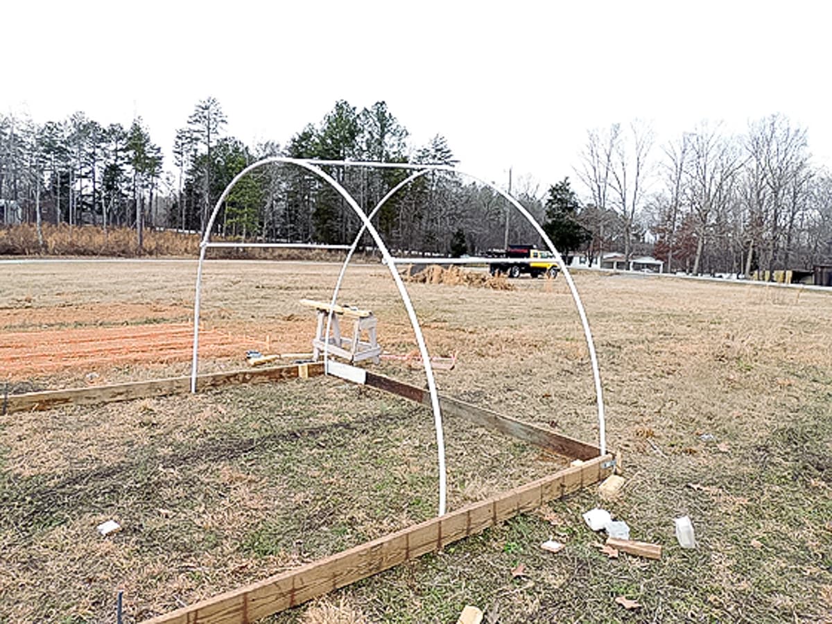 one pvc section is up on the frame of the greenhouse