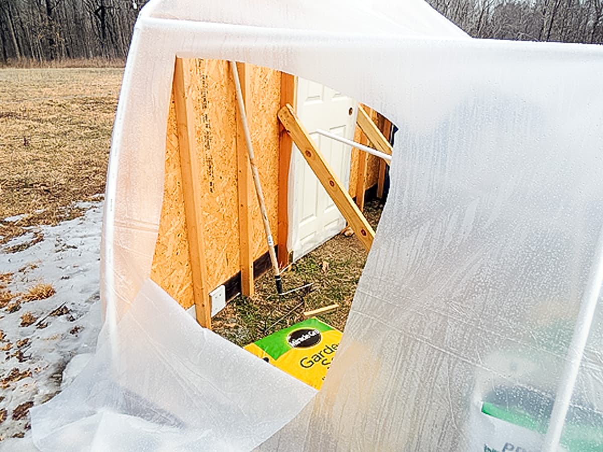 cutting a hole in the greenhouse