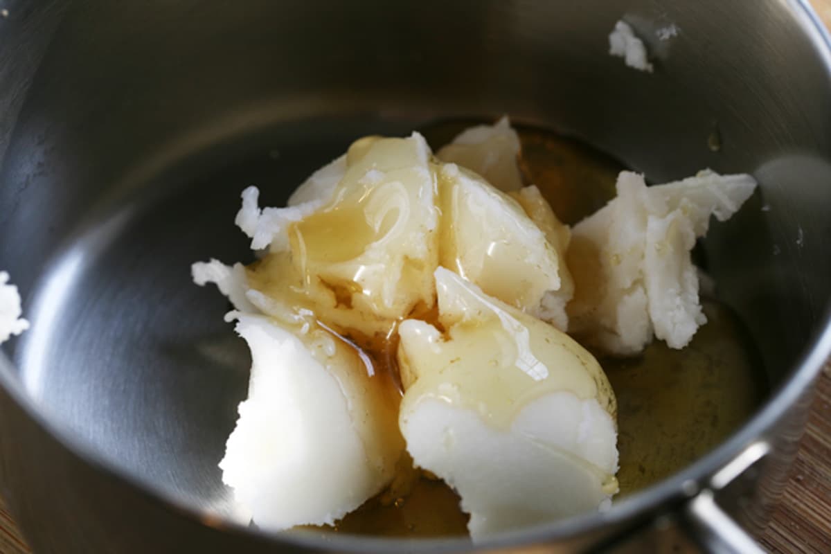 placing sugar and honey in a pot