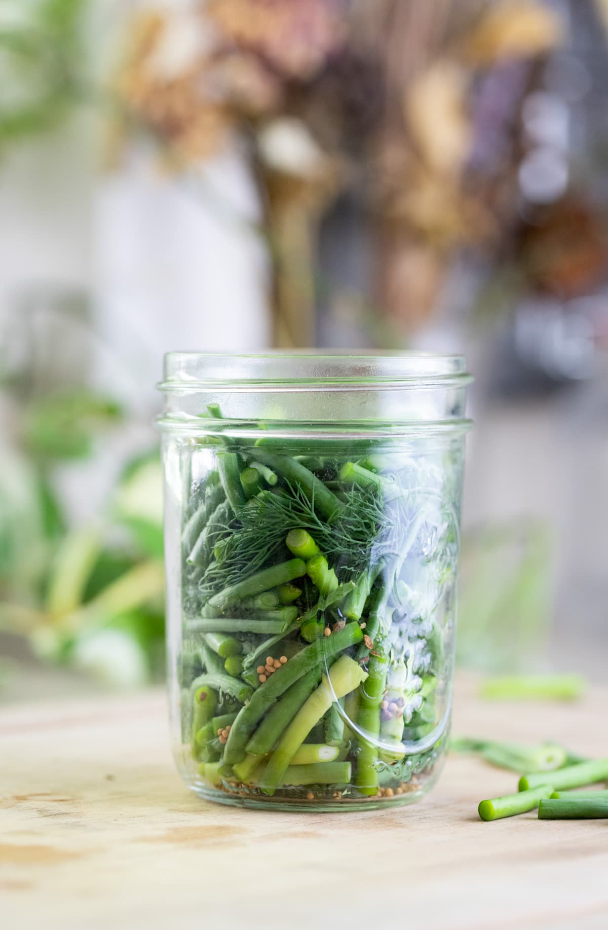 jar packed with garlic scapes