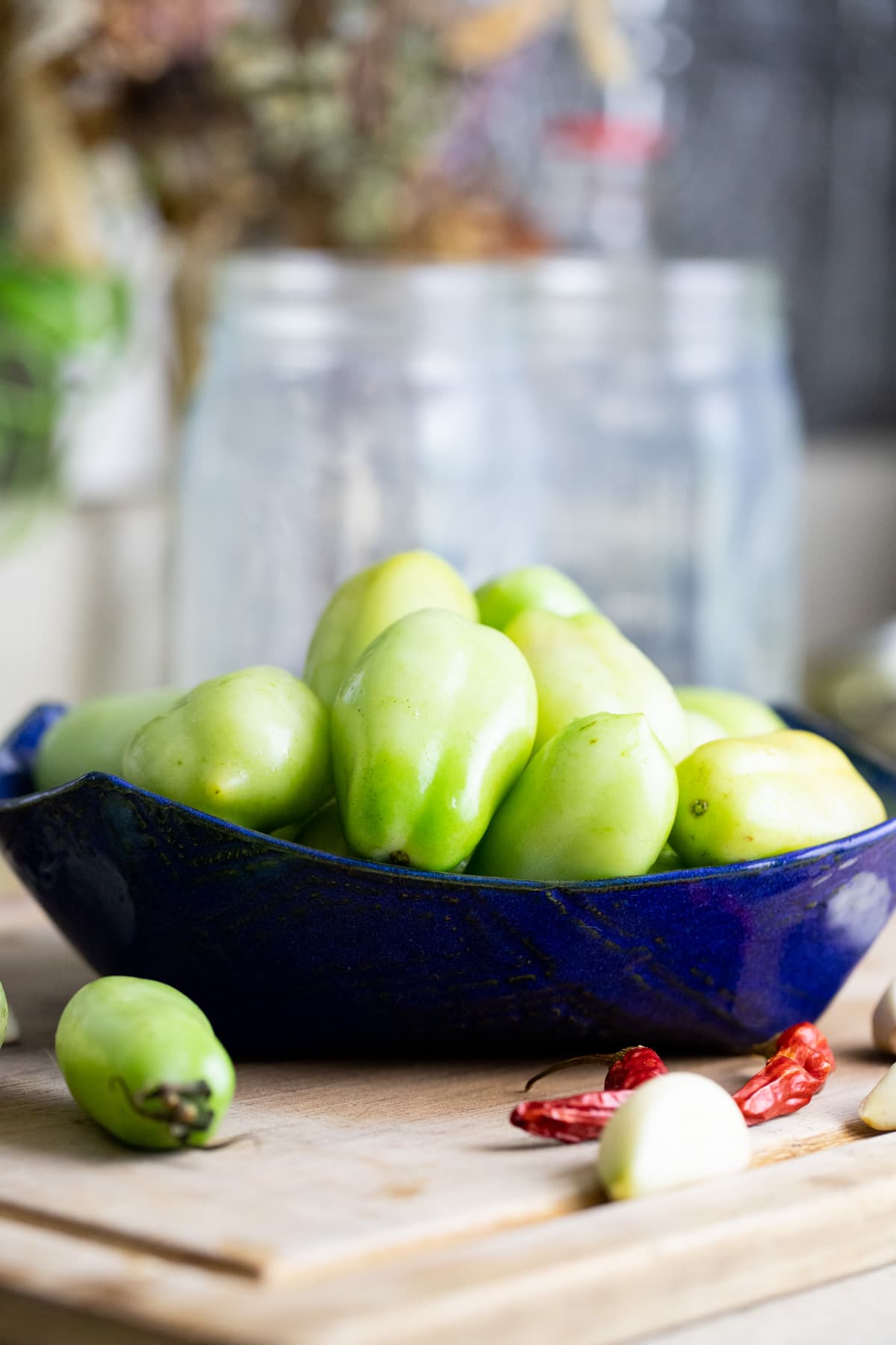 a bowl of green tomatoes ready for fermenting