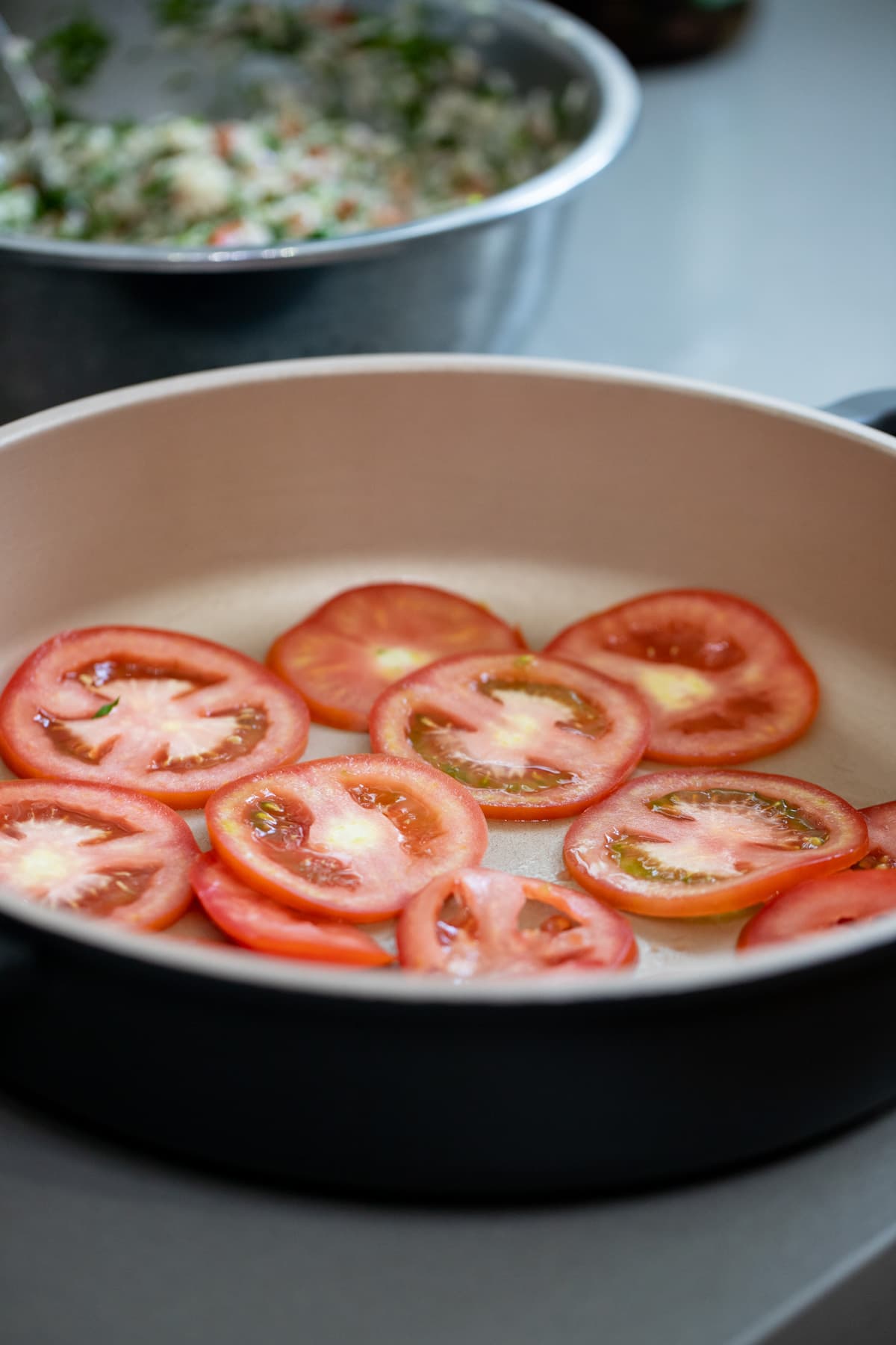 adding a layer of tomatoes on the bottom of the pot