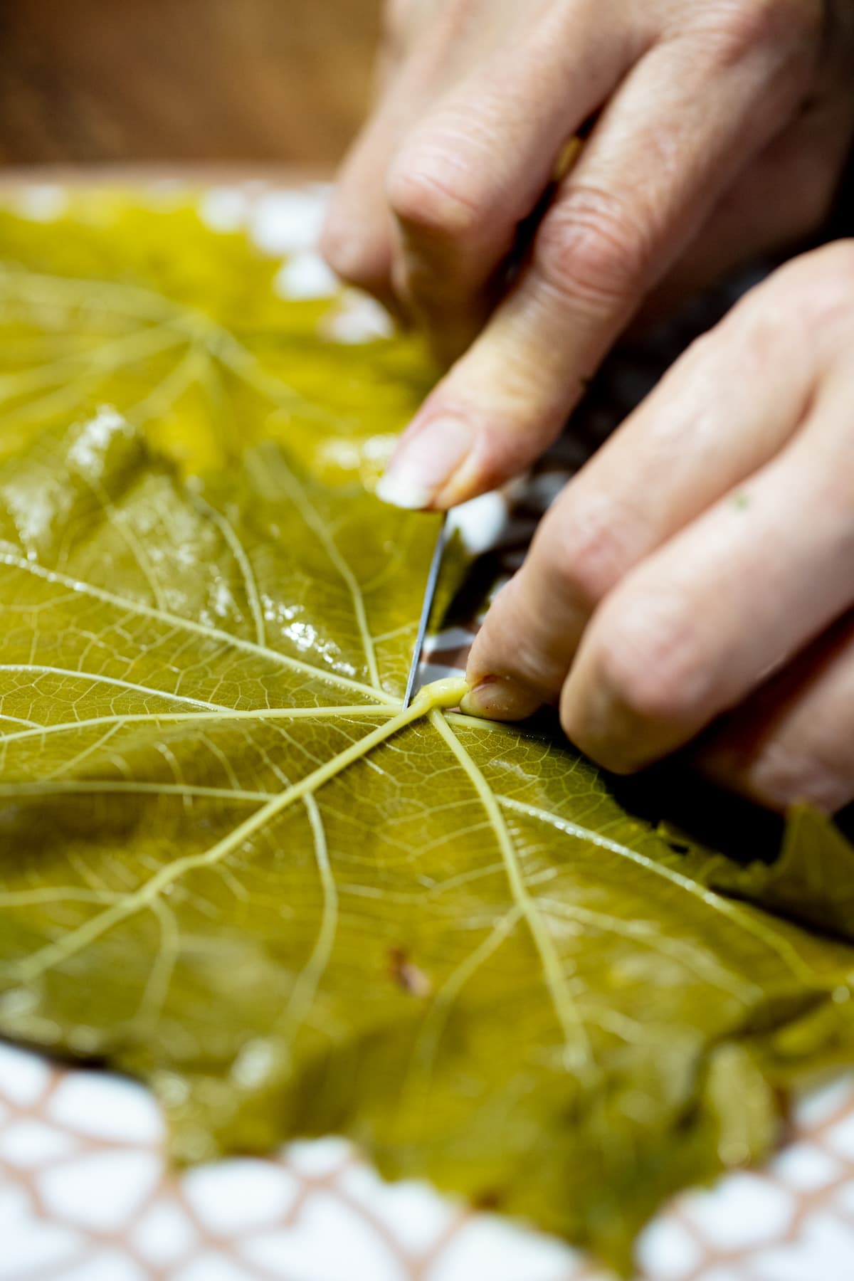 removing the stems of the grape leaves