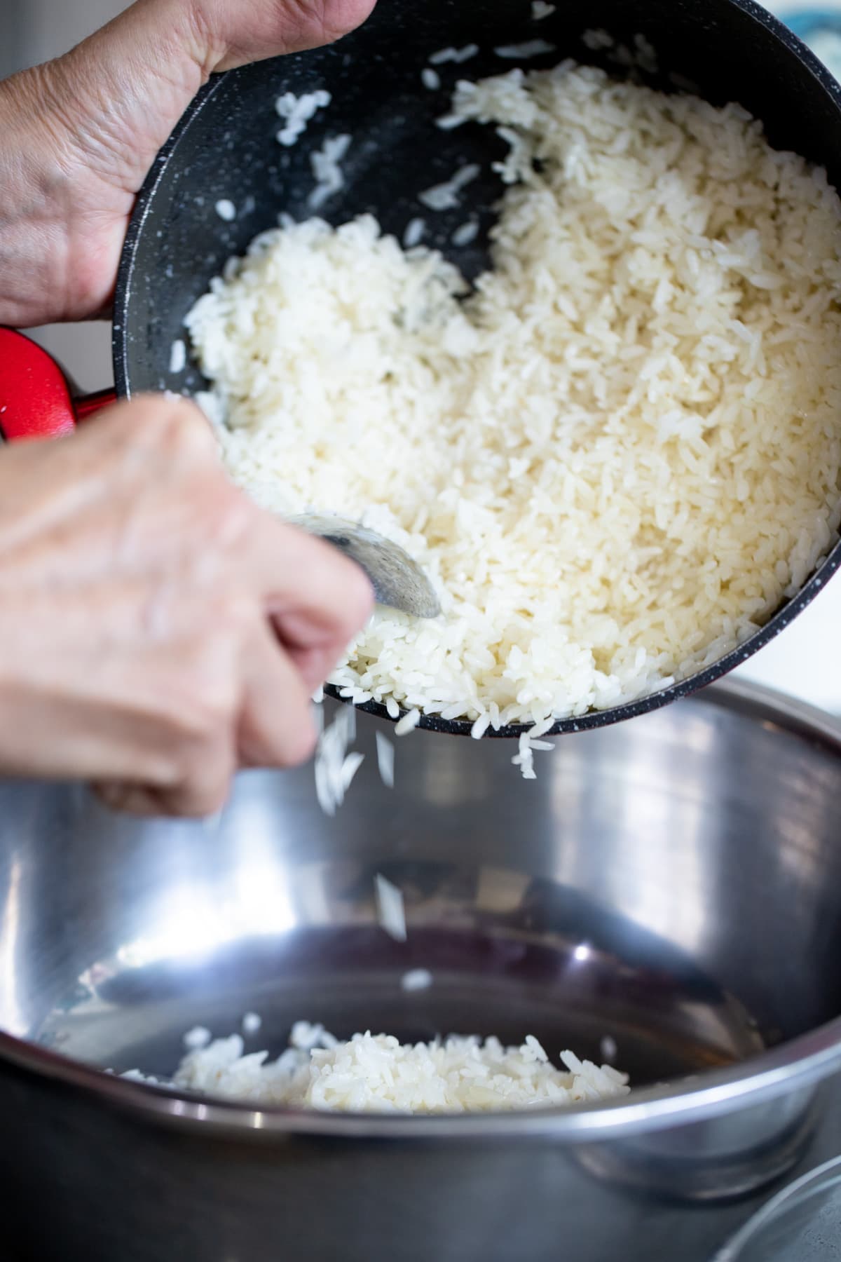 transferring cooked rice to a bowl