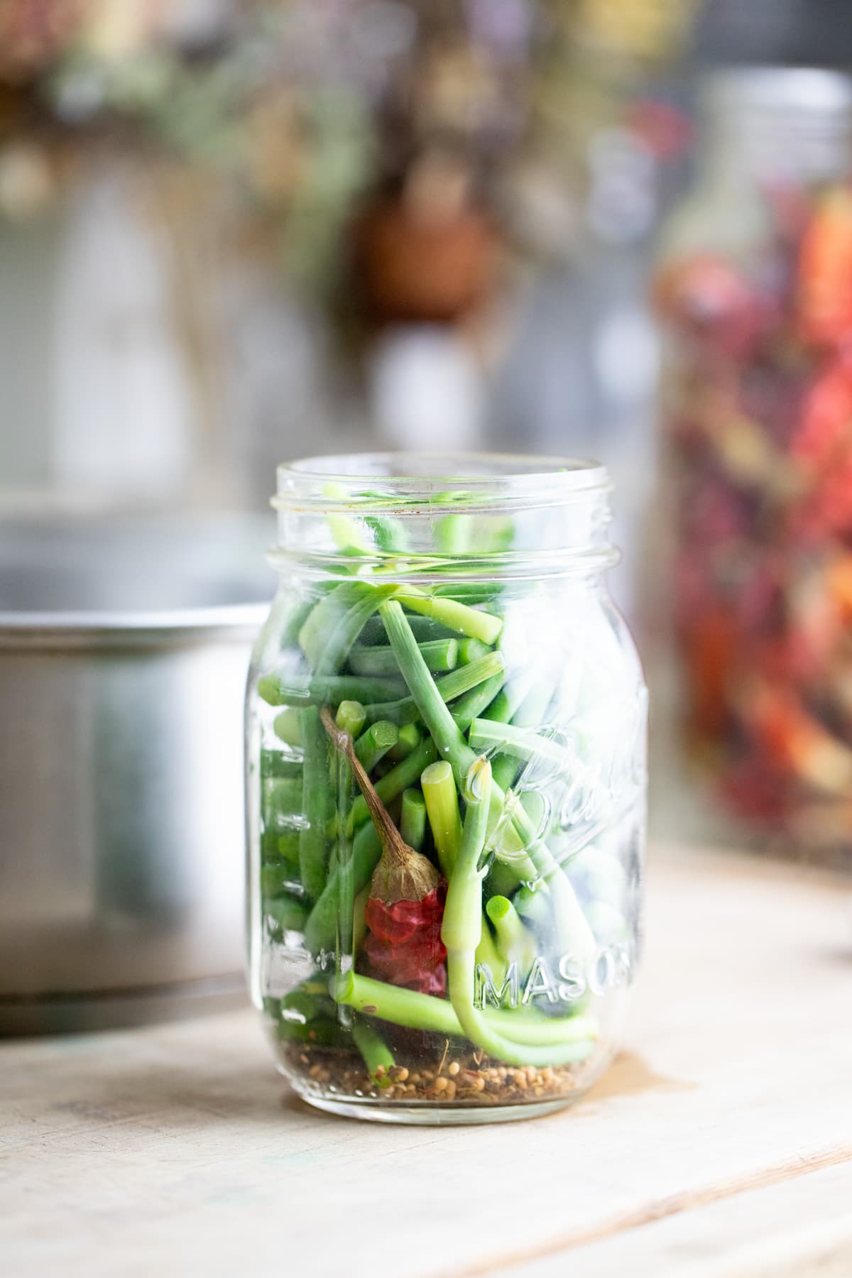 pacing the jar with the spices and scapes