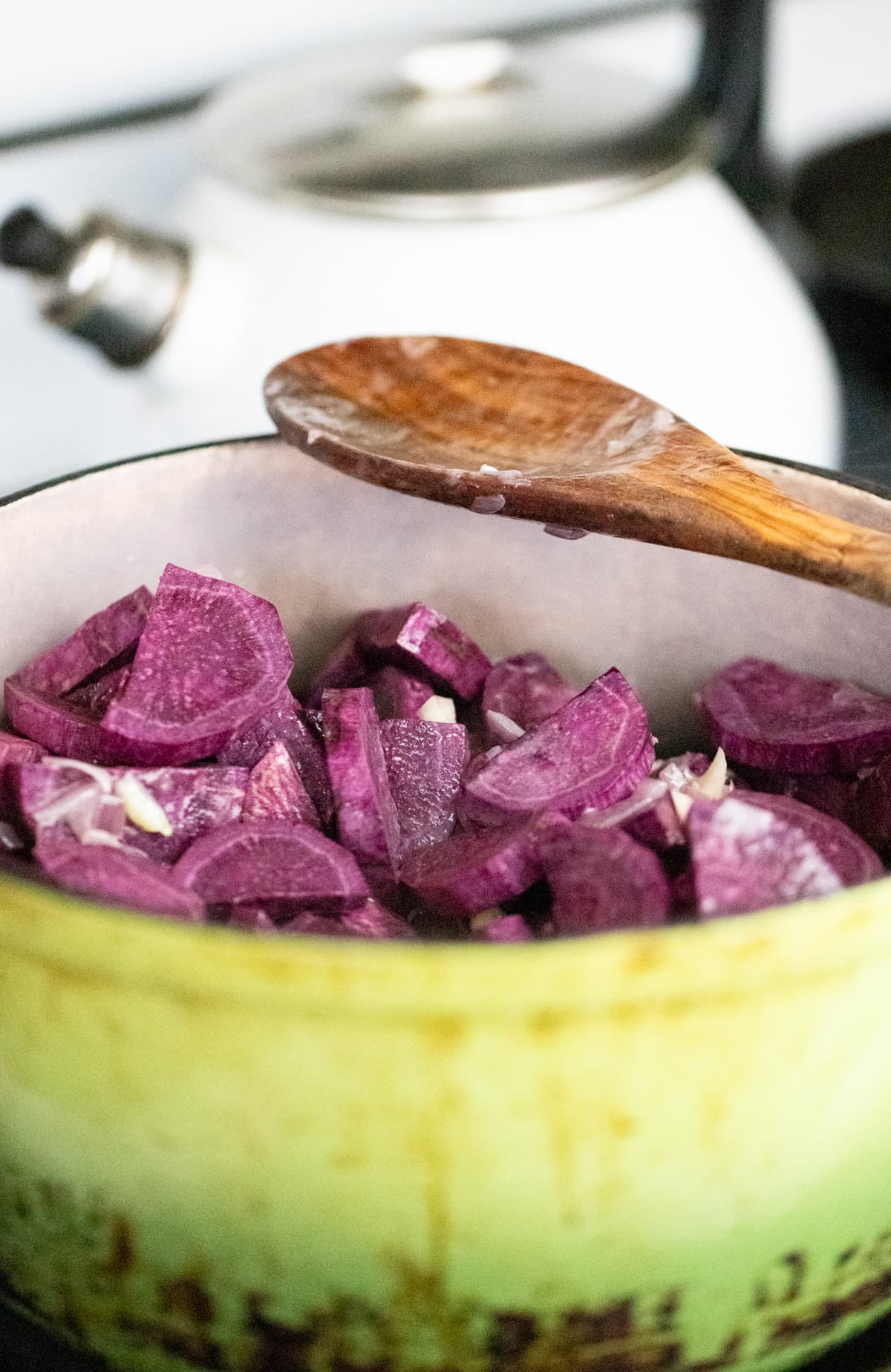 frying the purple sweet potatoes with onions and garlic
