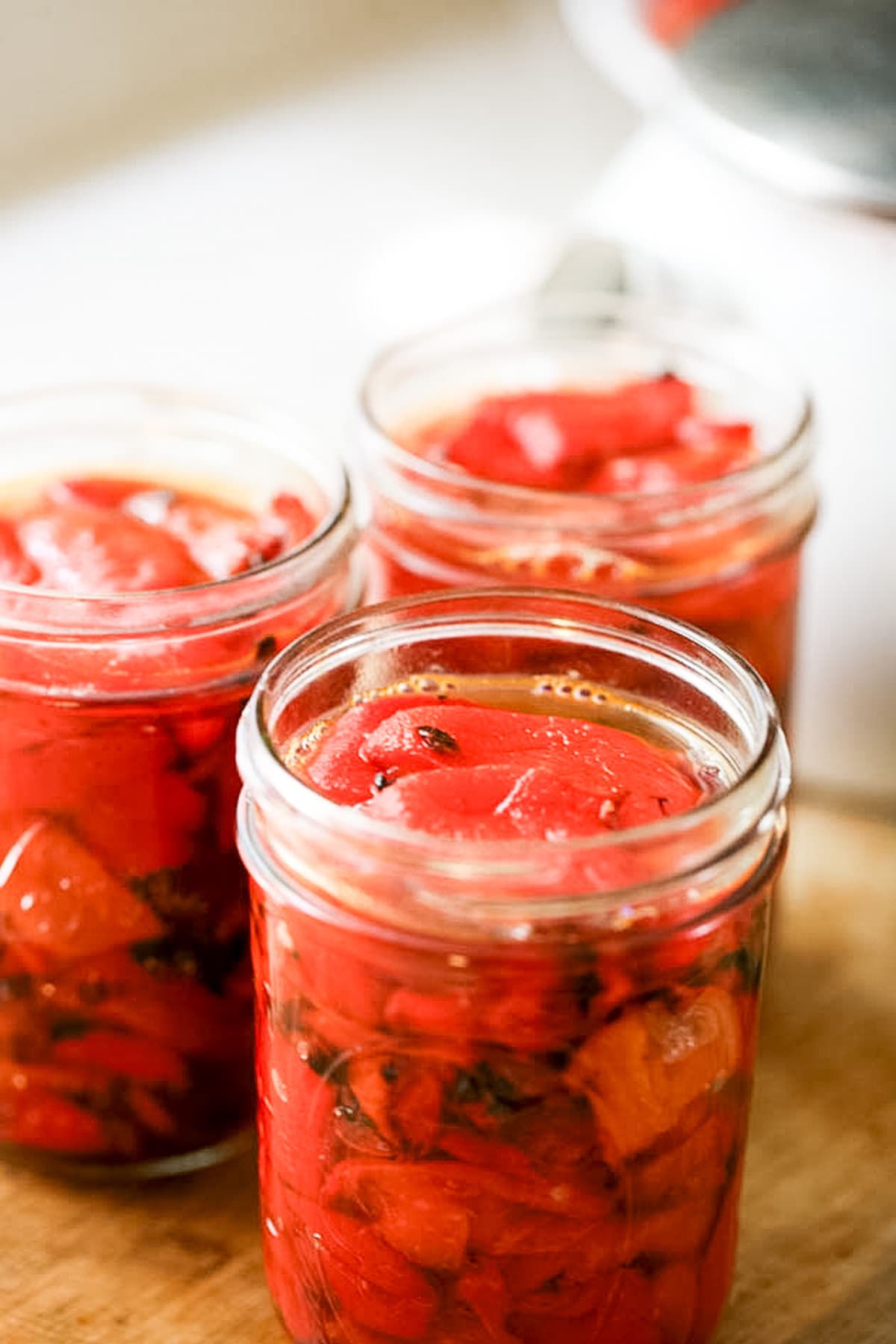 adding liquid to each jar