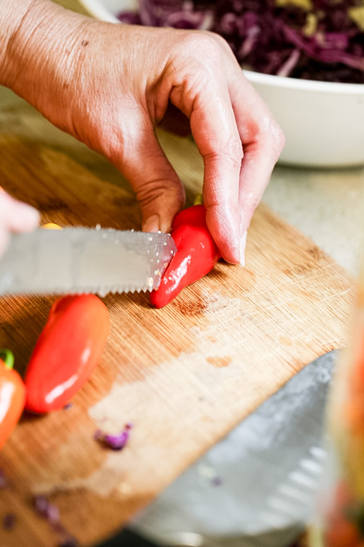 cutting a slit at the bottom of the peppers