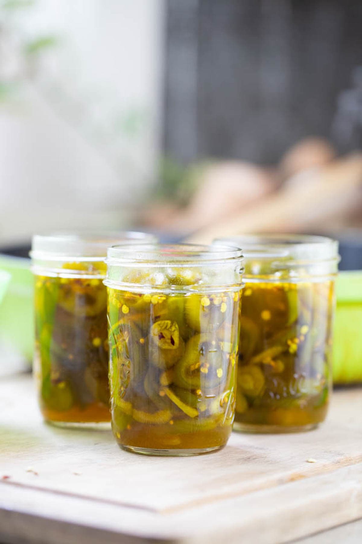 packing the jars with the candied jalapenos