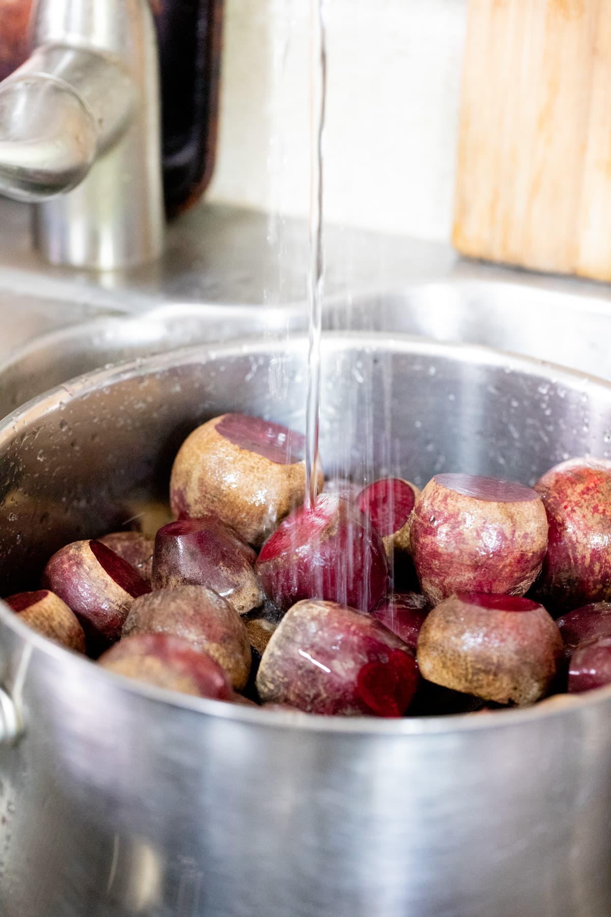 adding water to the pot with beets