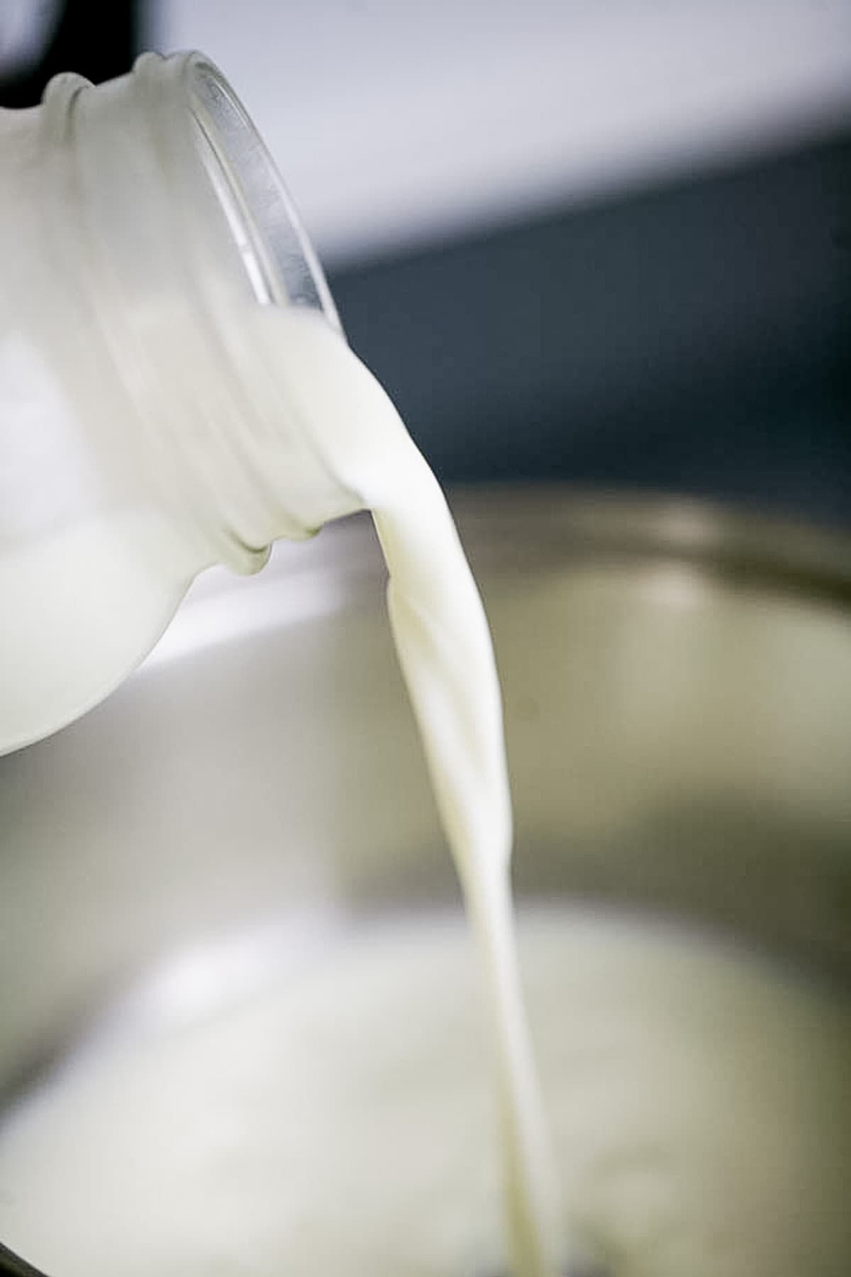 adding raw goat milk to pot