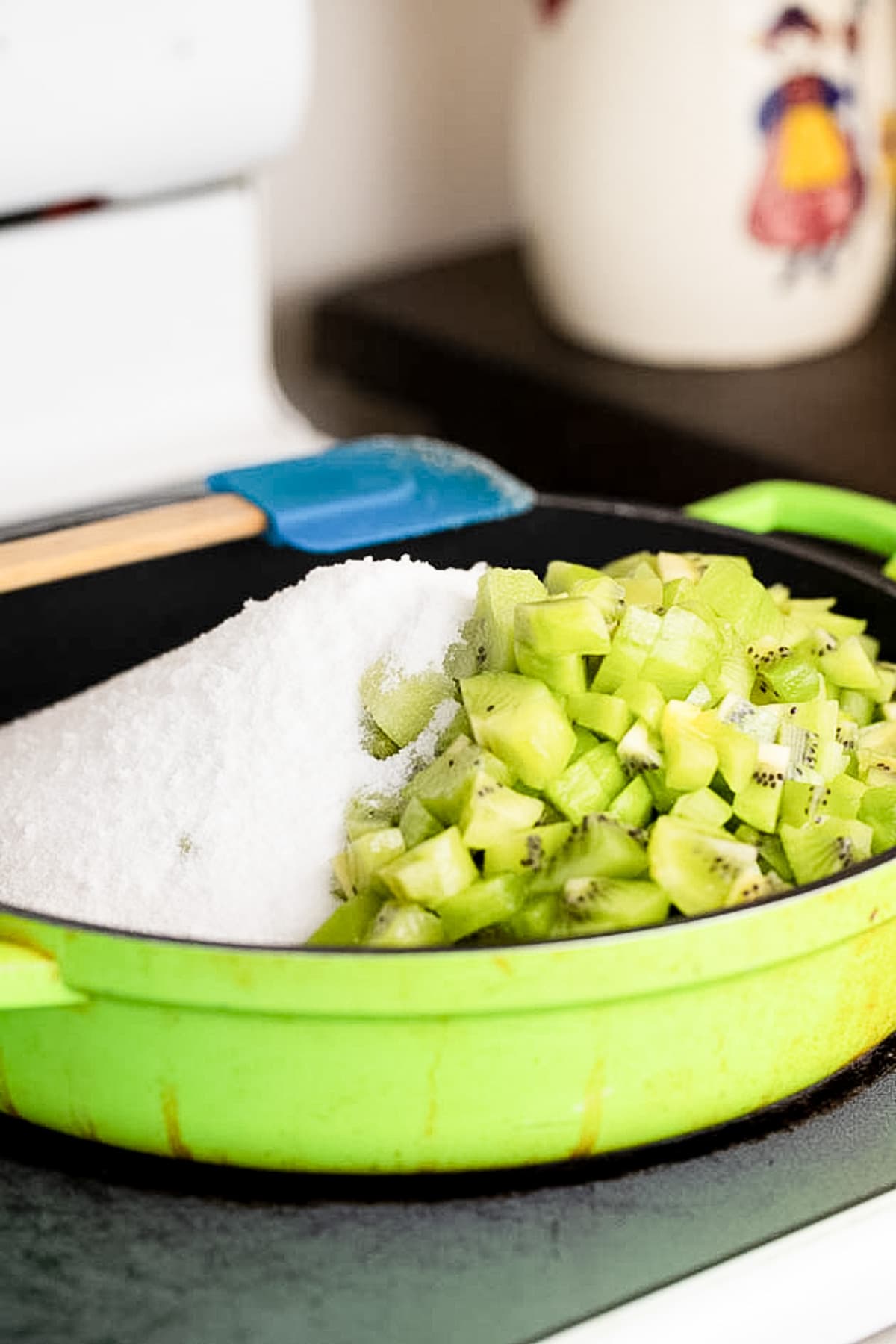 diced kiwi and sugar in a pan