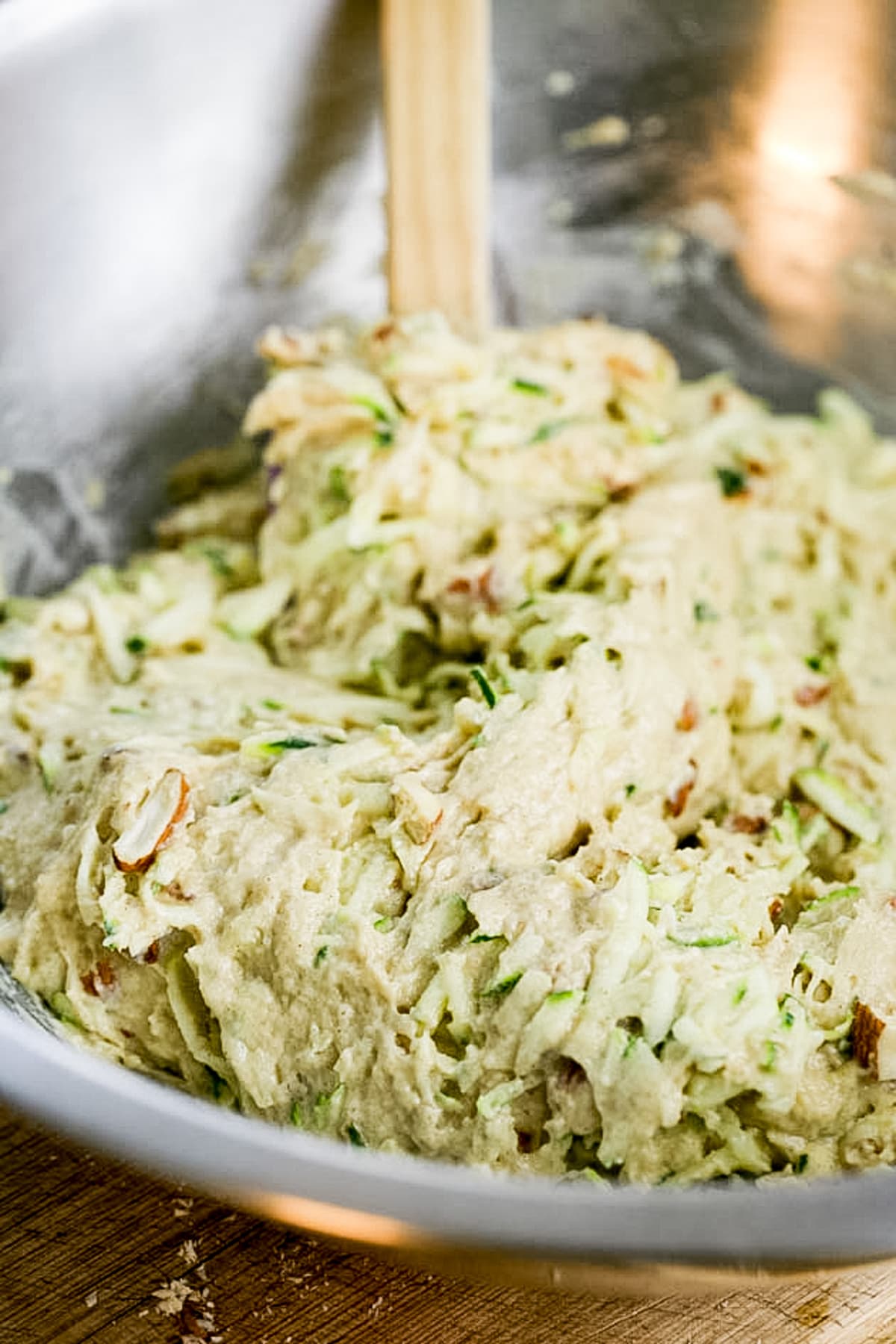 mixing nuts and zucchini into the batter